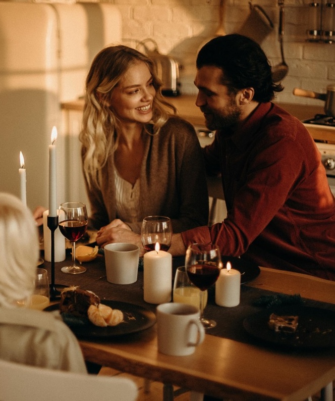 couple-having-dinner Woman and man having dinner at a table with wine glasses and lit candles