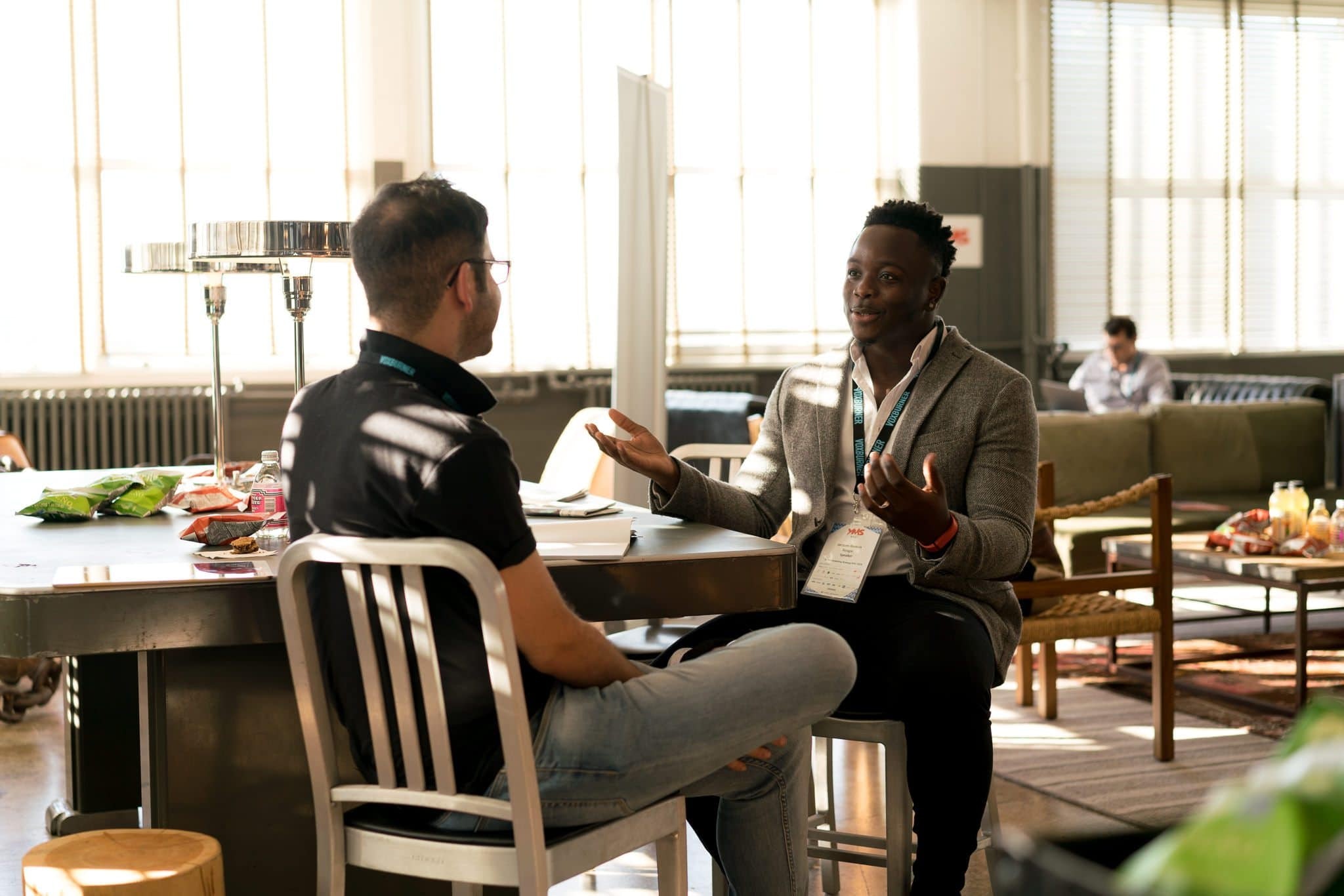 Two men sitting at a table discussion business